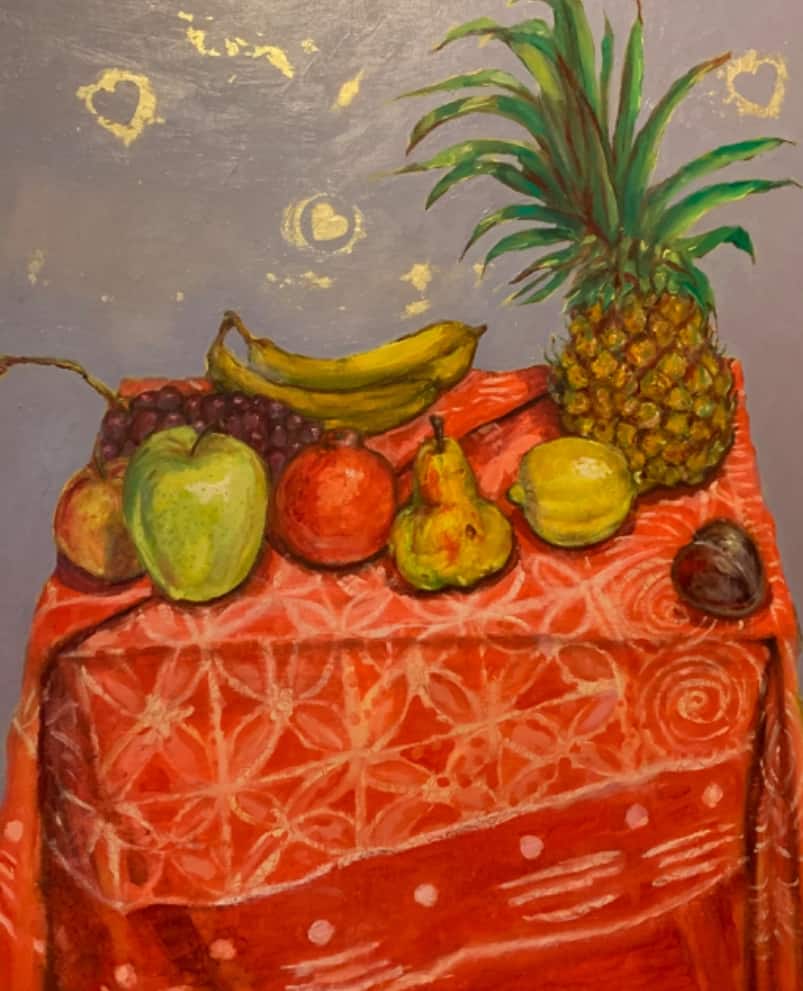 still life of fruit on orange patterned tablecloth